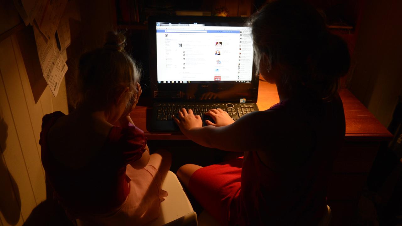 Young girls use a personal computer in Brisbane