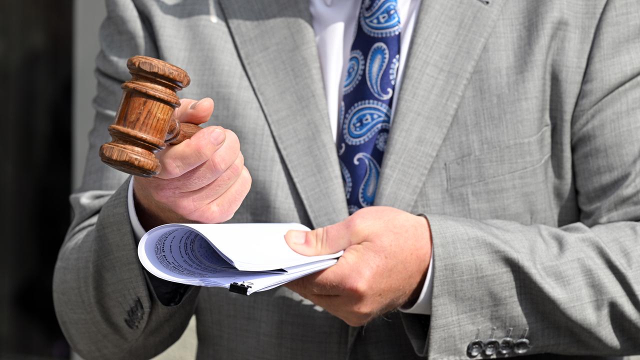 Auctioneer holds a gravel