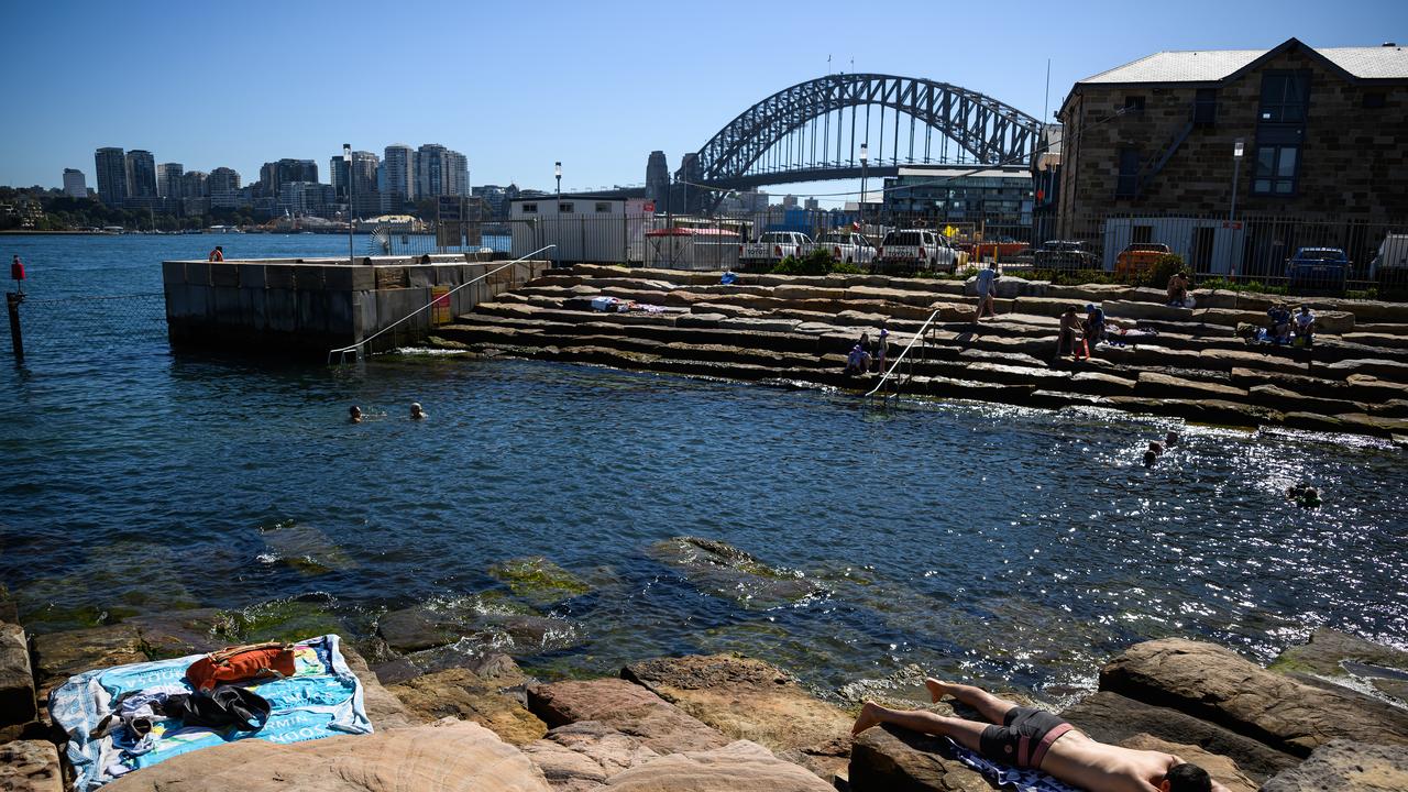 People sunbath at Marrinawi Cove in Sydney