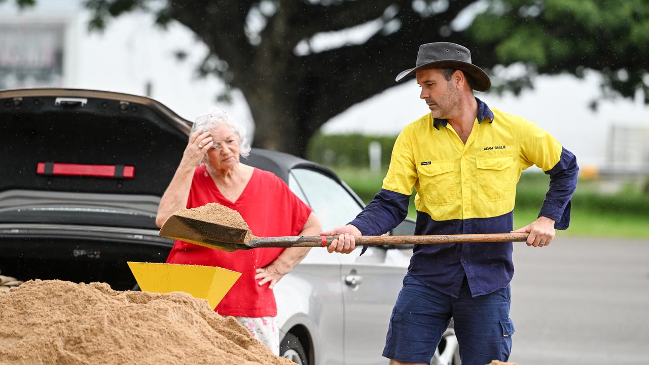 Local residents fill sandbags in preparation for severe weather