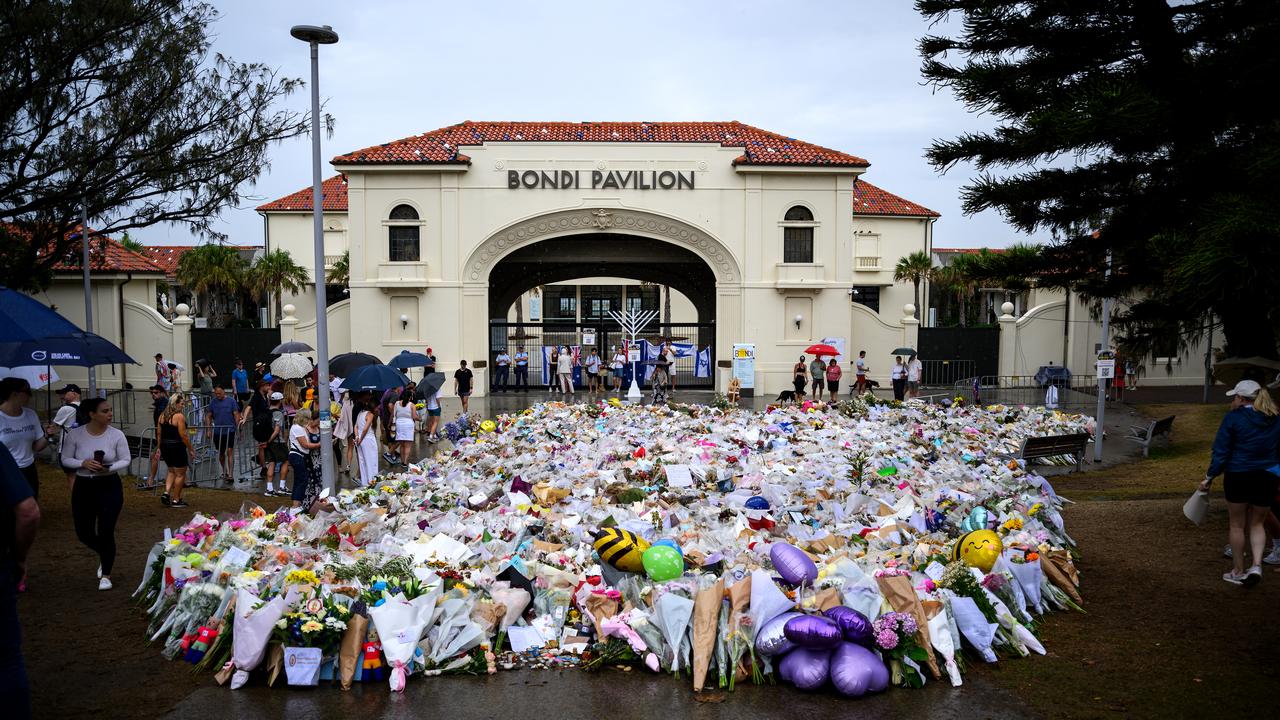 Mourners place flowers at a memorial at Bondi Beach in Sydney