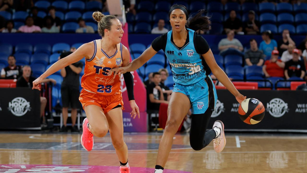 Kadiatou Sissoko of the Capitals drives past Townsville's Abbey Ellis.