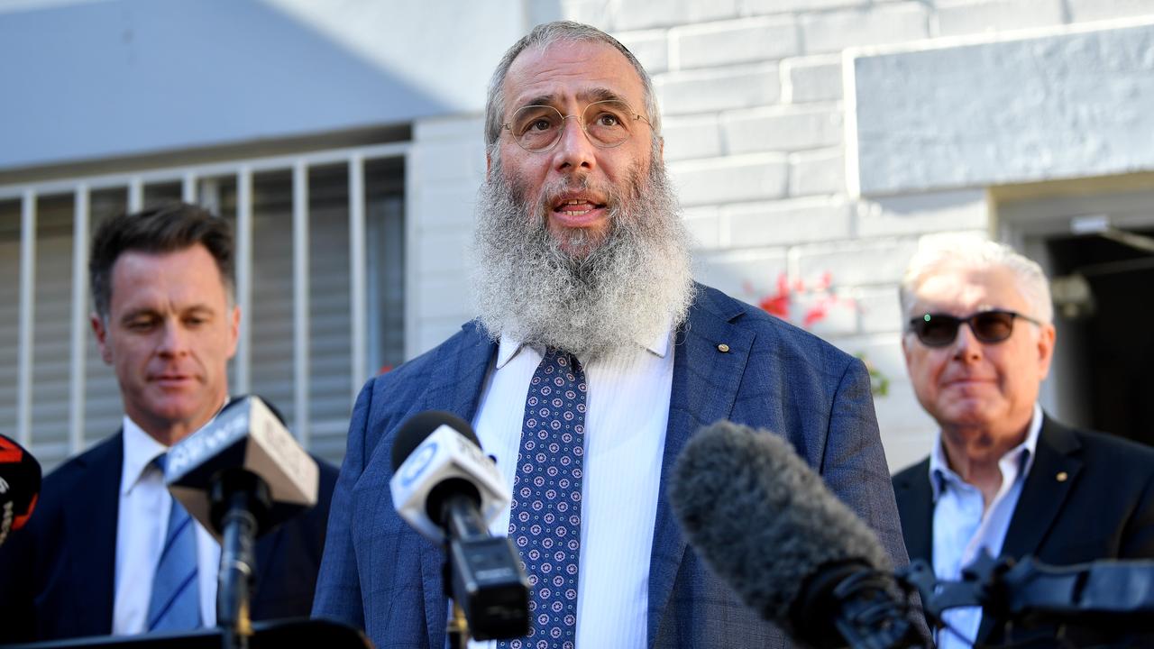 Rabbi Mendel Kastel speaks to the media