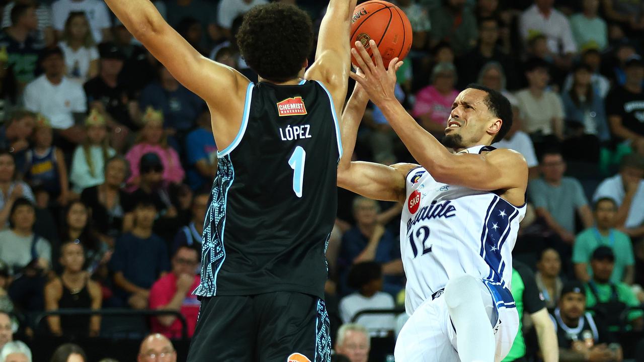 John Jenkins tries to get a shot over the Breakers'  Karim Lopez.
