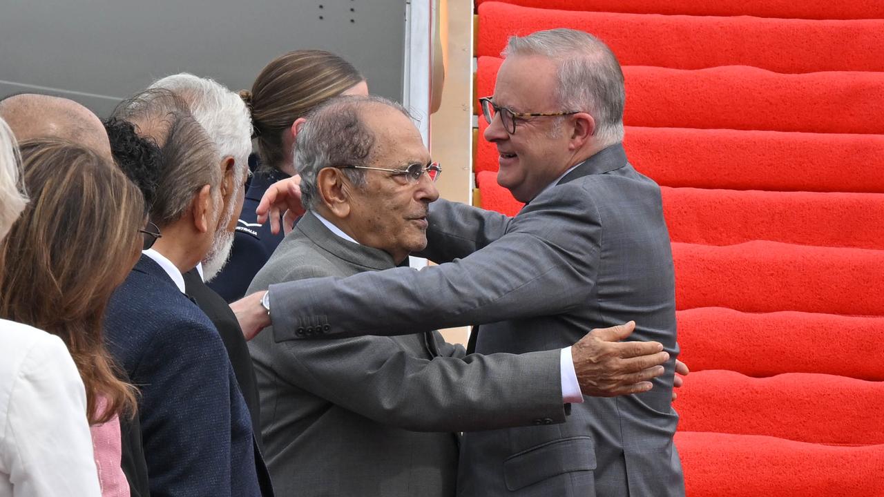 Anthony Albanese is hugged by Jose Ramos Horta