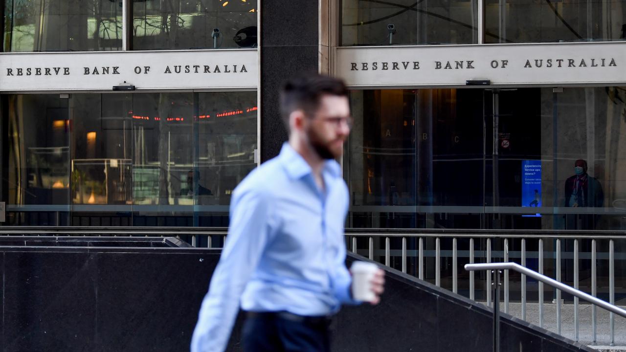 pedestrian walks past the Reserve Bank of Australia