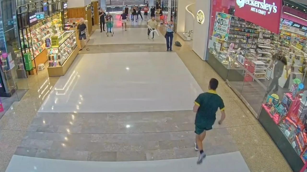 Joel Cauchi runs towards Inspector Amy Scott