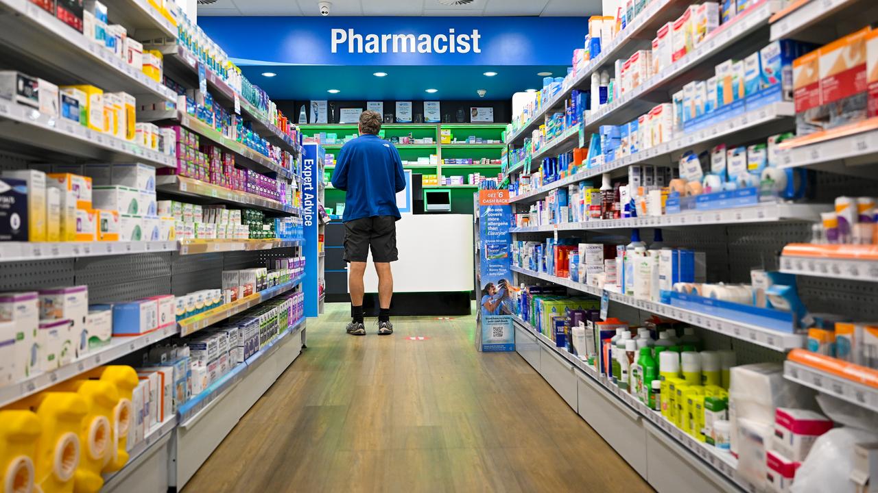 A customer waits at a counter at National Chemist pharmacy
