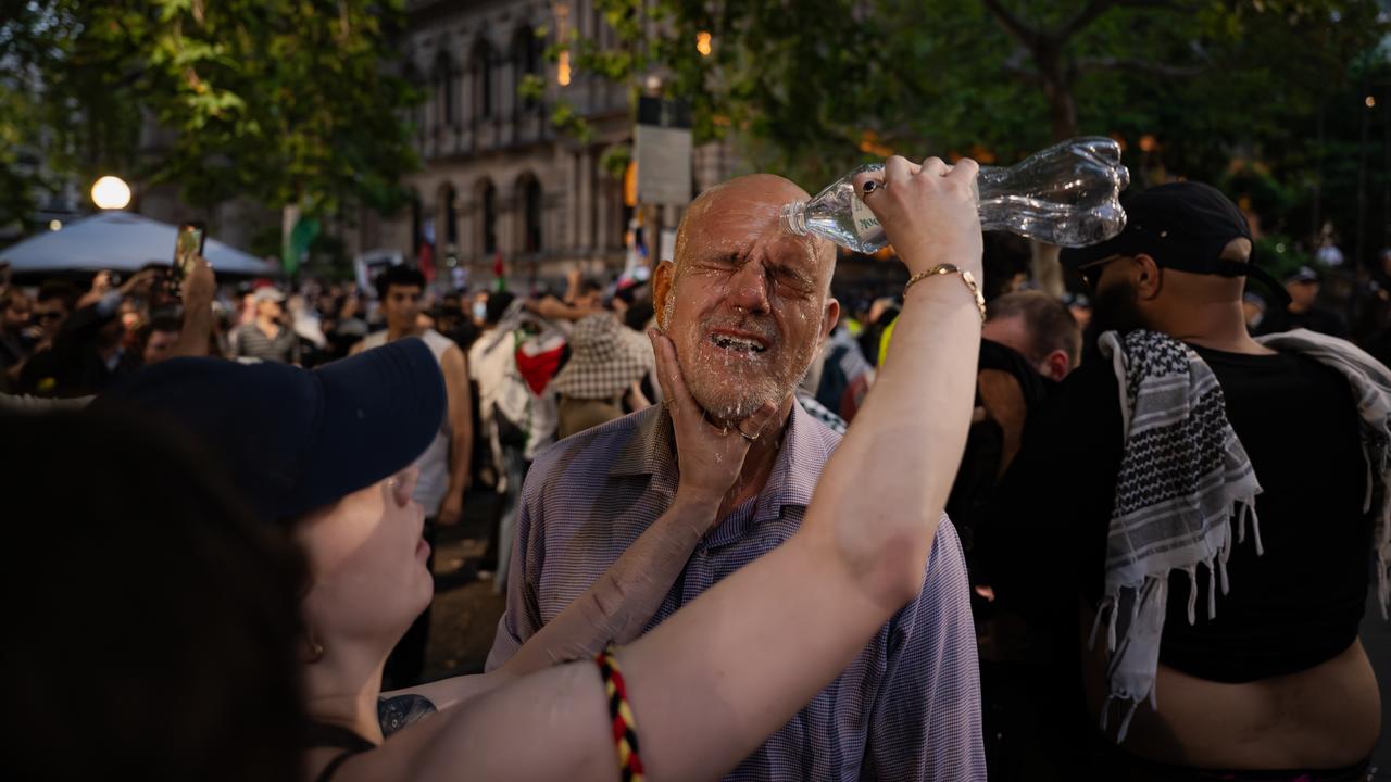 Protesters react after being exposed to pepper spray