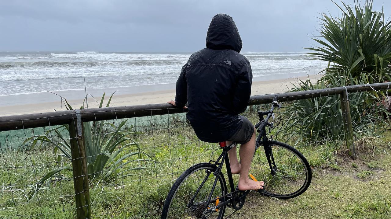 Man on pushbike at beach