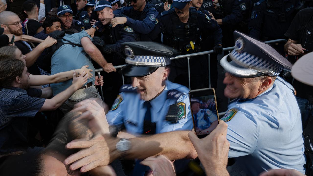 Police officers detain demonstrators