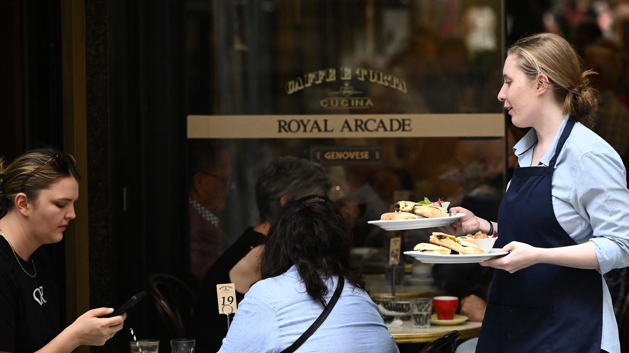 A cafe worker serves coffee 