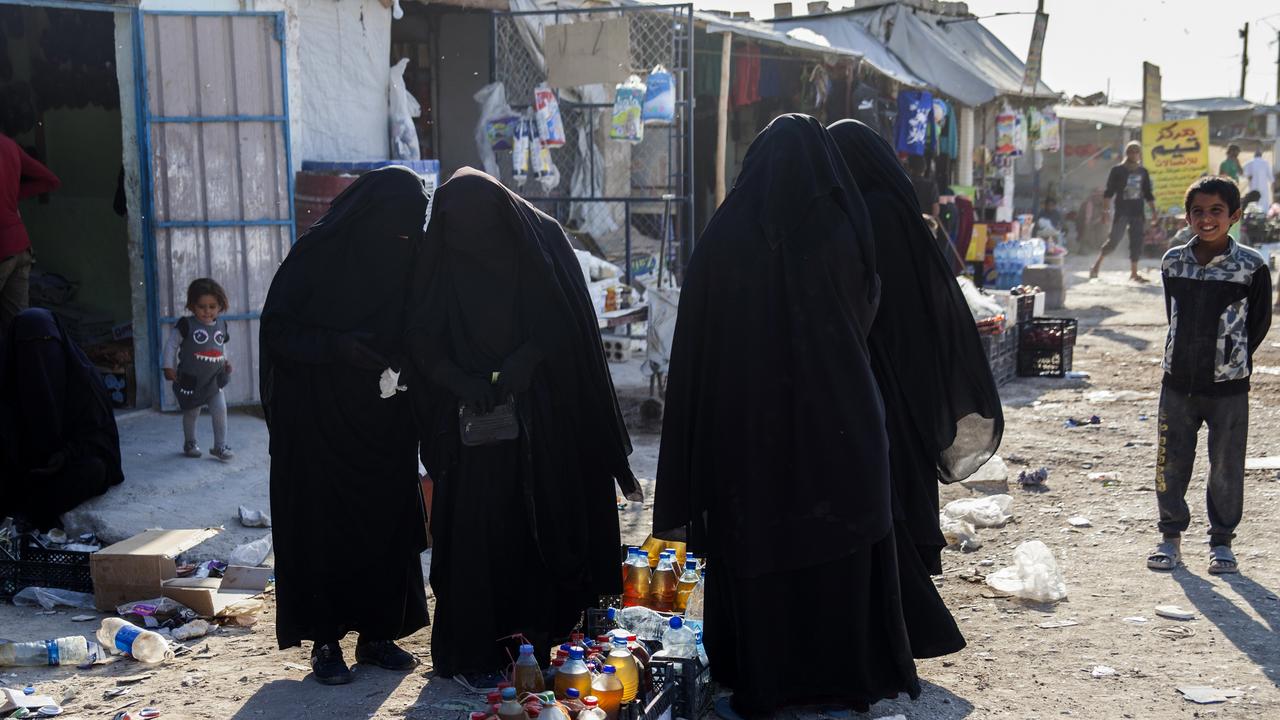 women buying food at the 'Iraqi market' in Al Hawl camp, Syria