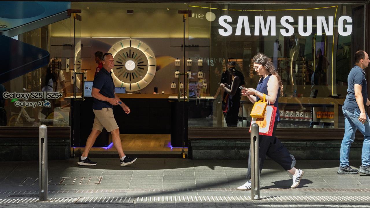 People walk past a Samsung store
