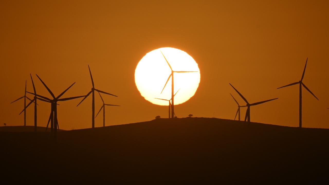 The sun rises over power-generating wind turbines (file image)