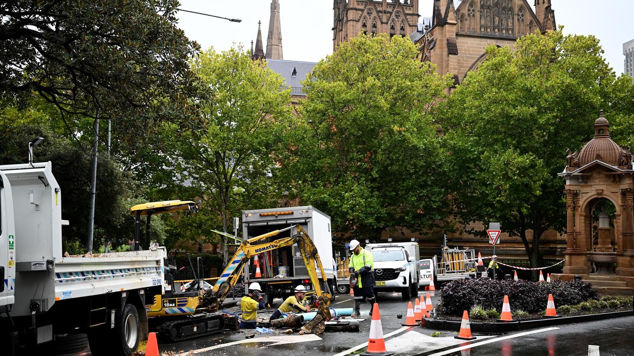 Sydney Water workers attend to a sink hole in Sydney