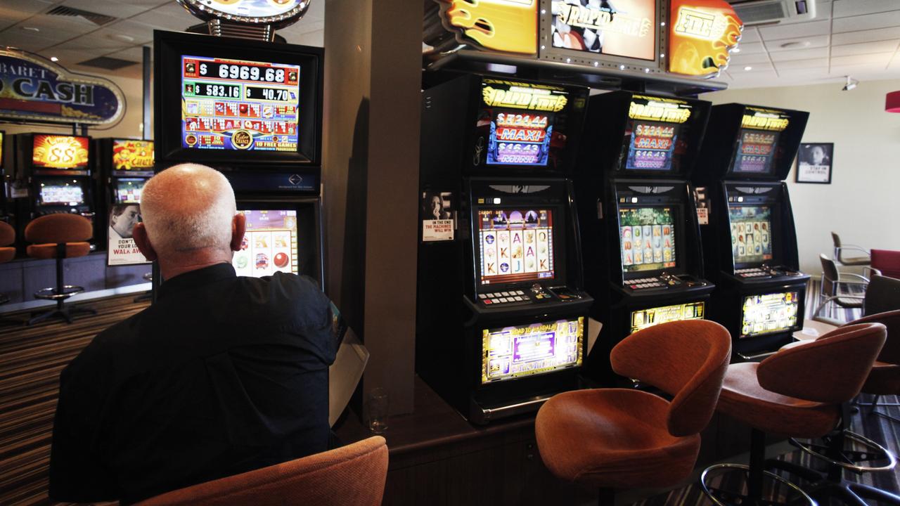 A man plays a pokie machine