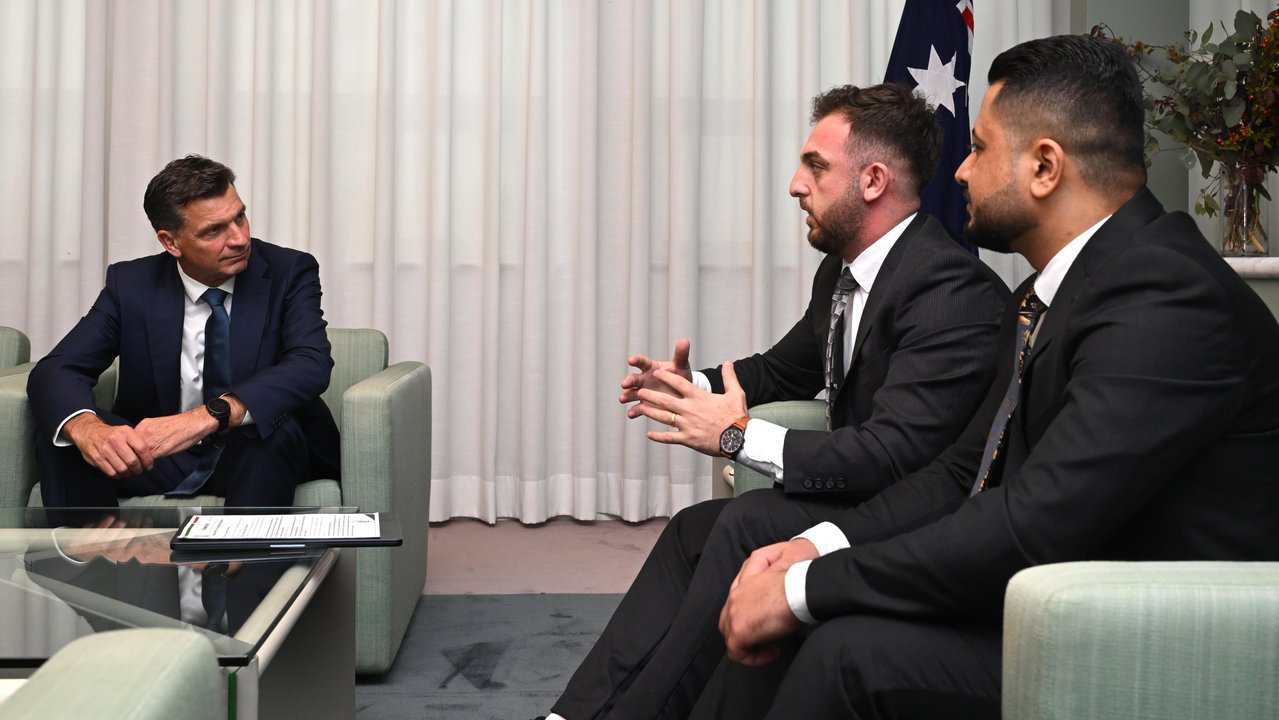 Angus Taylor listens to members of the Yazidi community