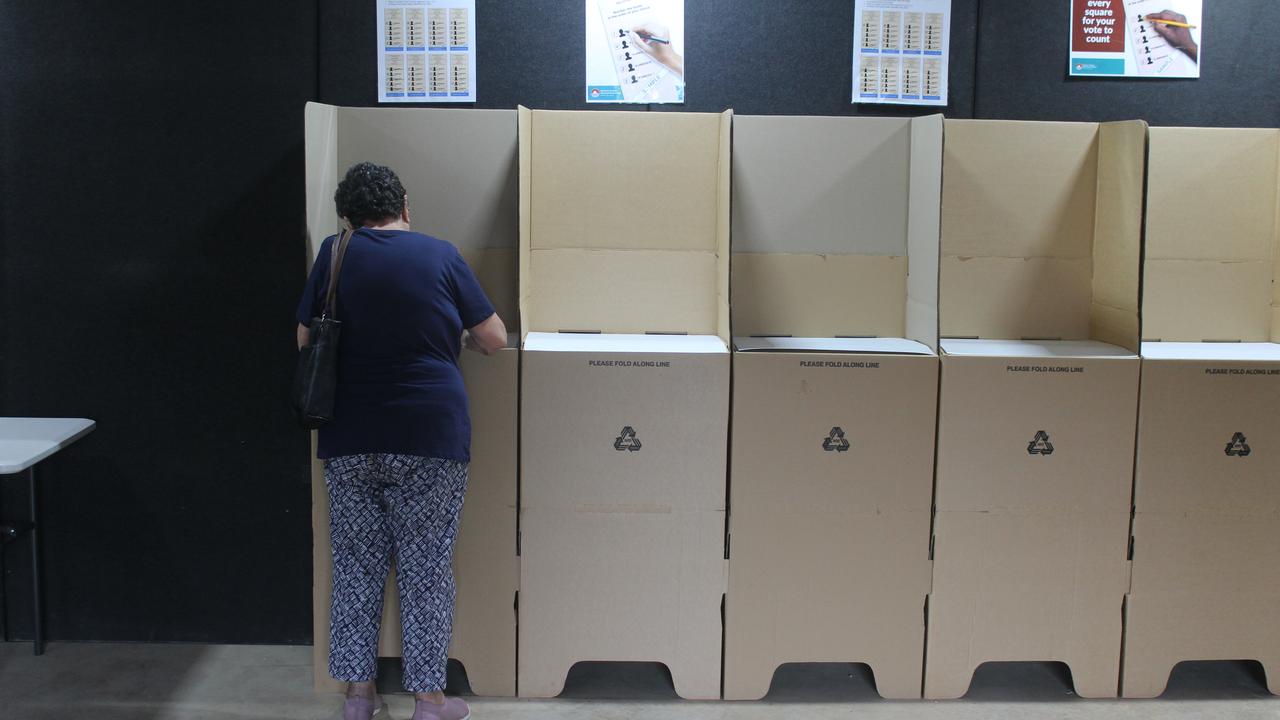 A woman votes at an early polling station in Nightcliff in Darwin