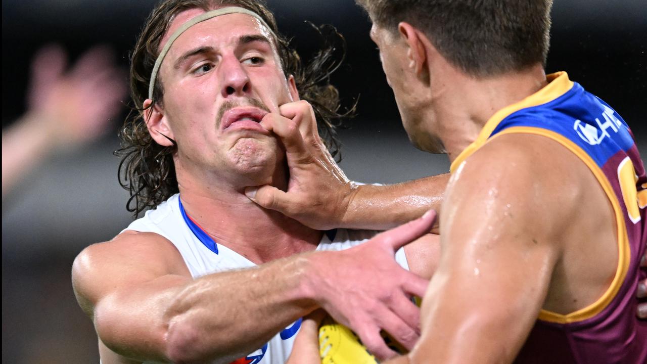 Brisbane's Zac Bailey (r) tangles with Bulldog Michael Sellwood.