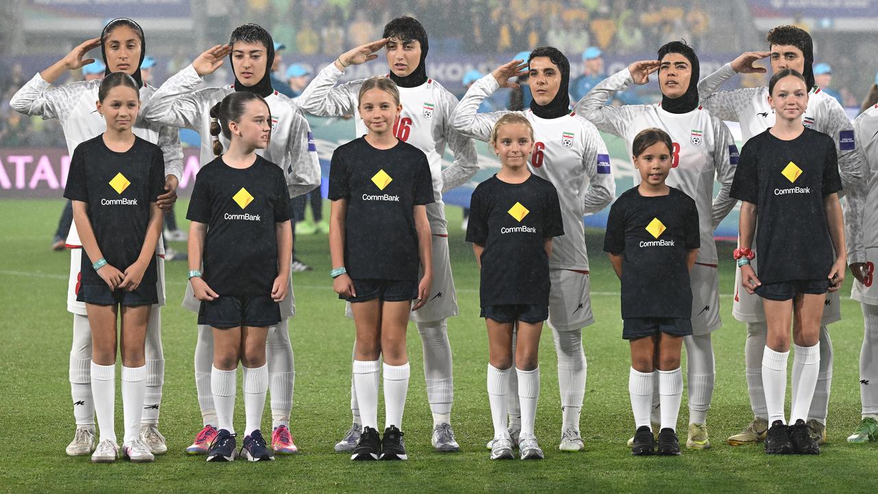 Iranian soccer players are seen during the National Anthem