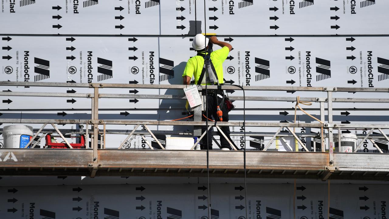 A construction worker installing cladding (file image)
