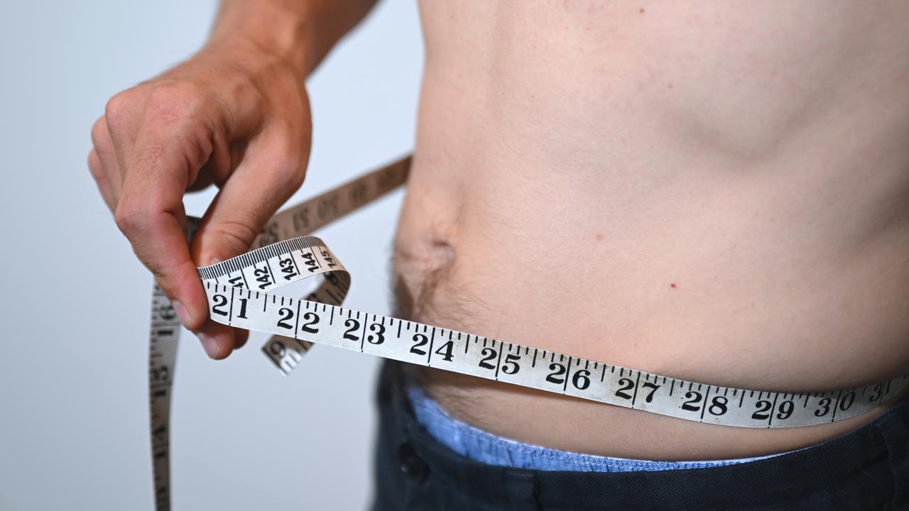 Man measuring his stomach