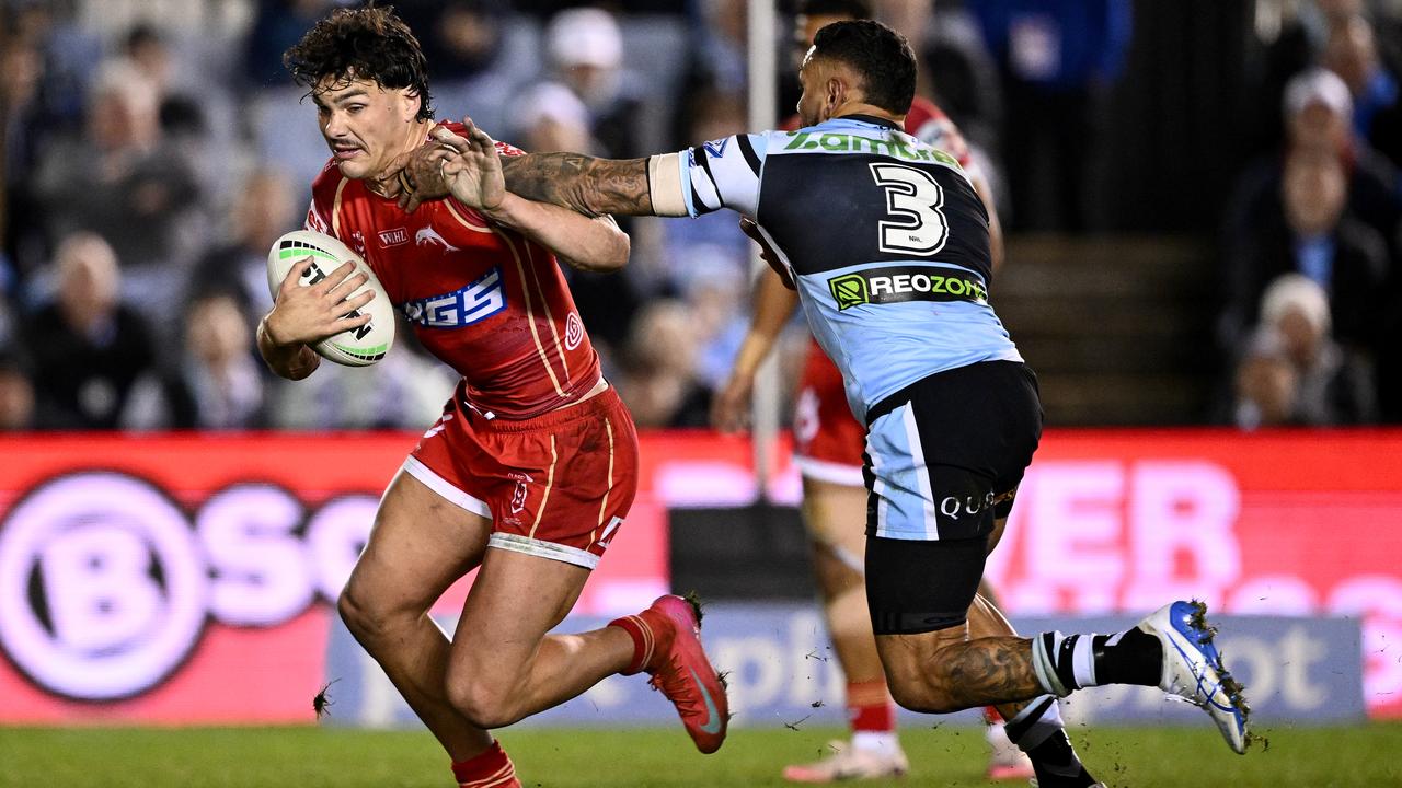 Herbie Farnworth of the Dolphins evades Jesse Ramien