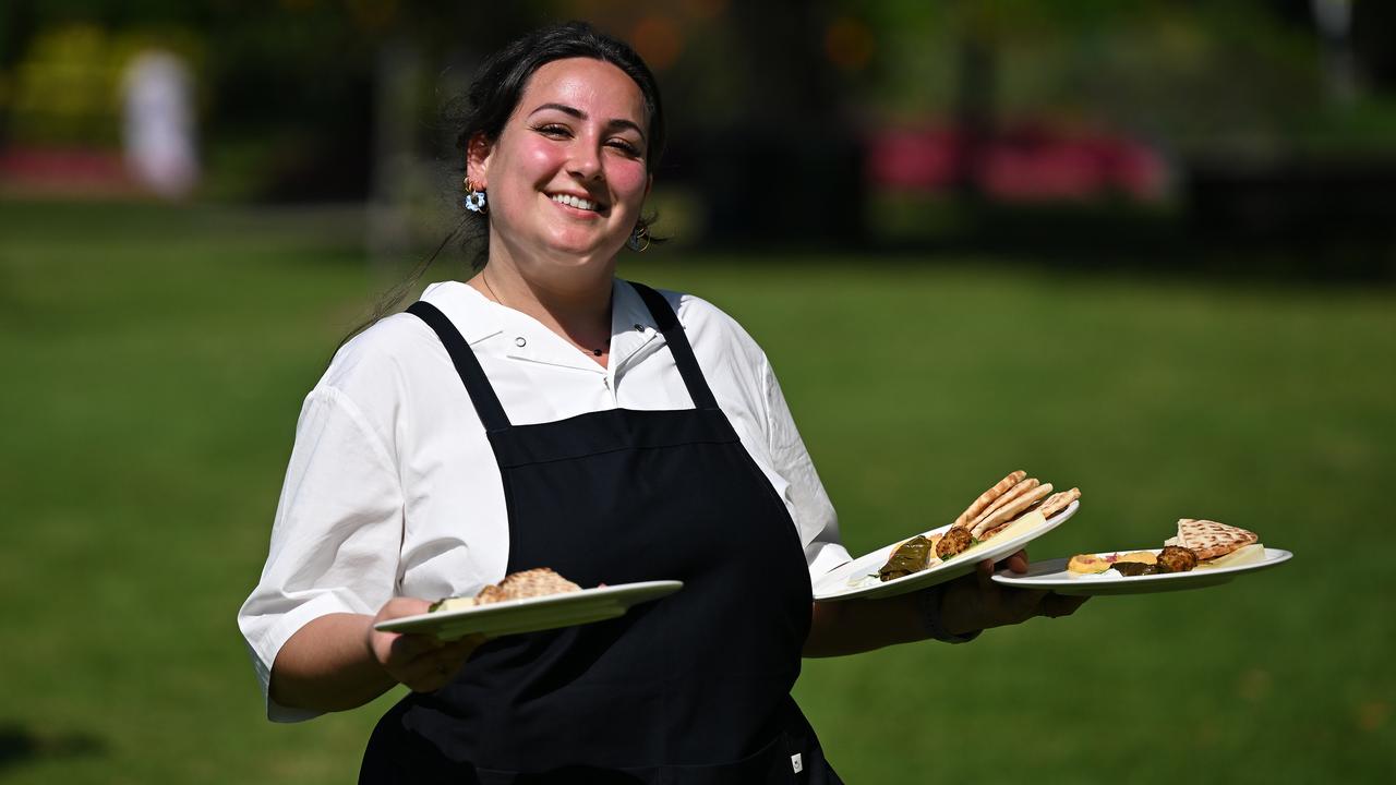 A waiter taking plates to a table