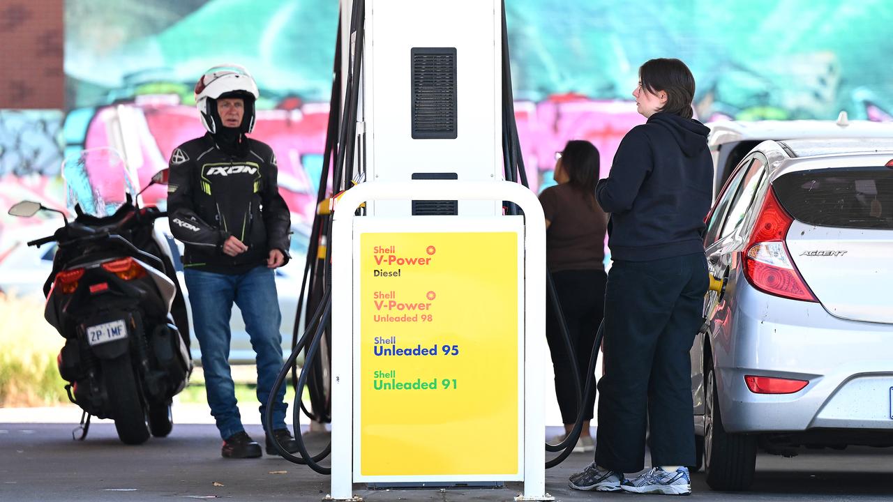 People fill up at a petrol station in Melbourne