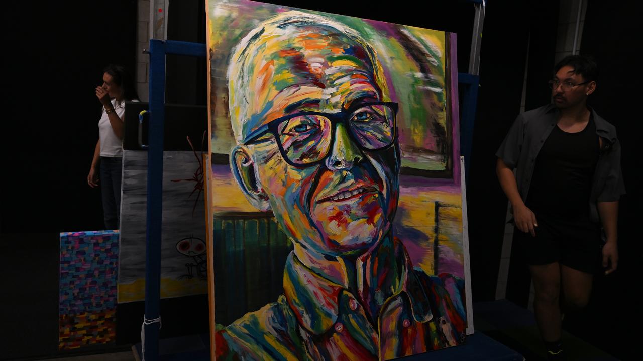 A packing room worker with Joel Coleman's artwork