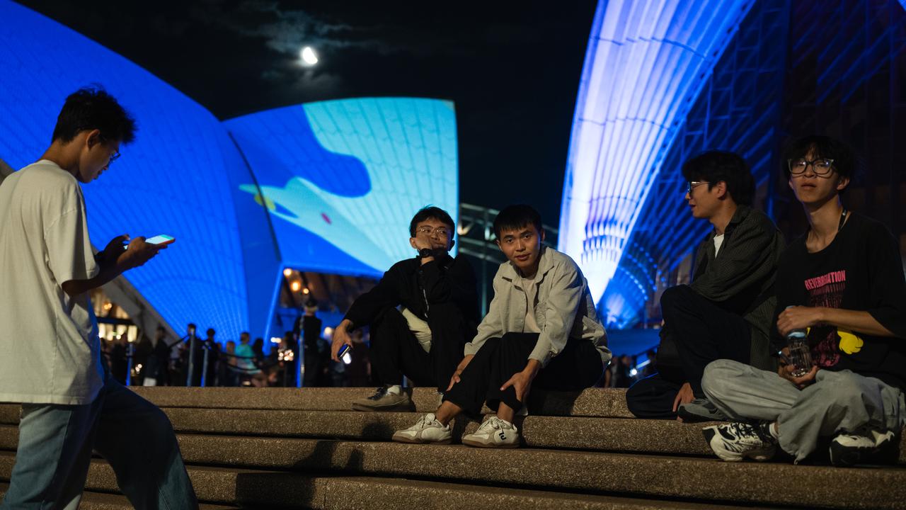 People watch designs projected onto the sails of 
Sydney Opera House