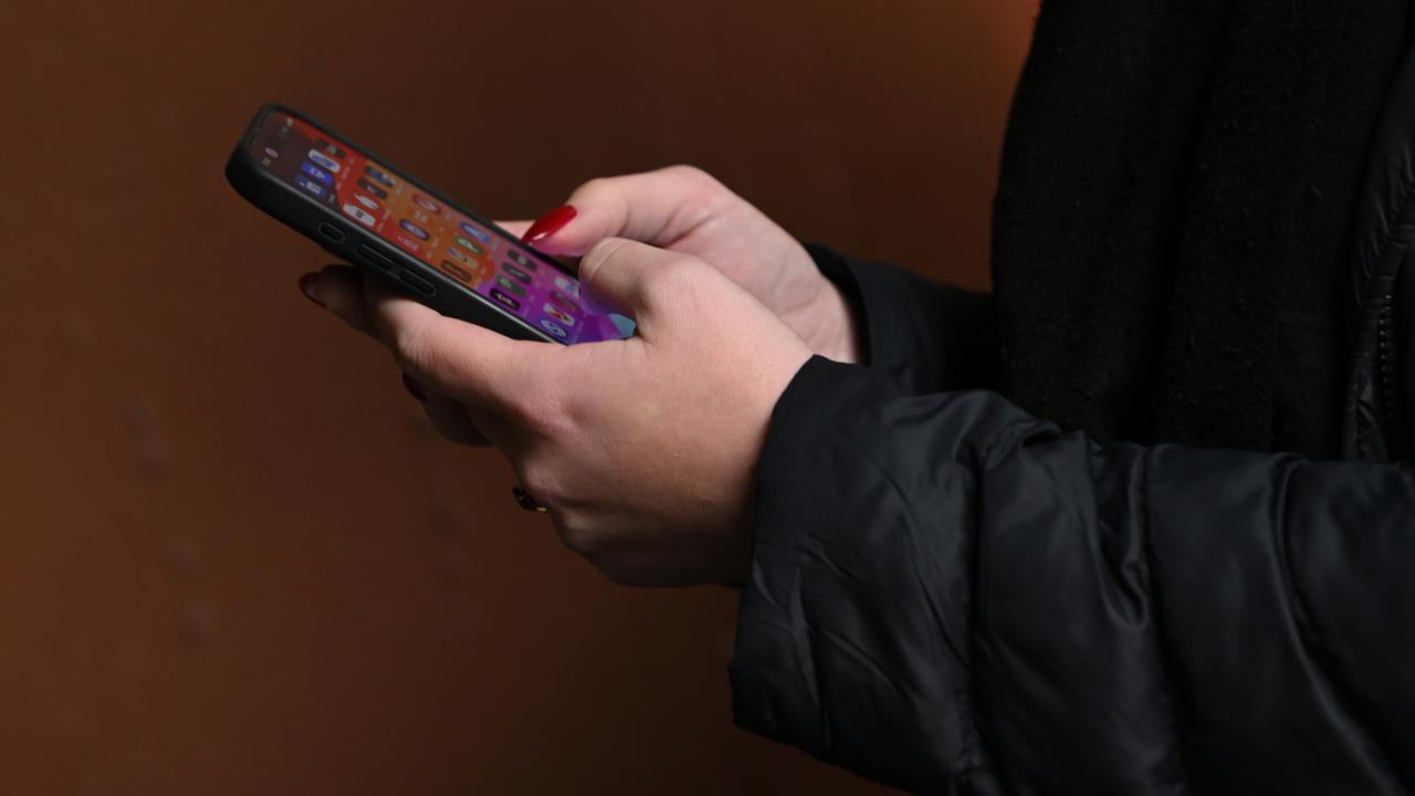 A person holding a mobile phone (file mage)