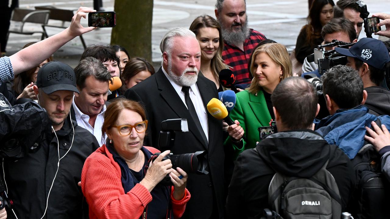 Kyle Sandilands (centre) departs the Federal Court