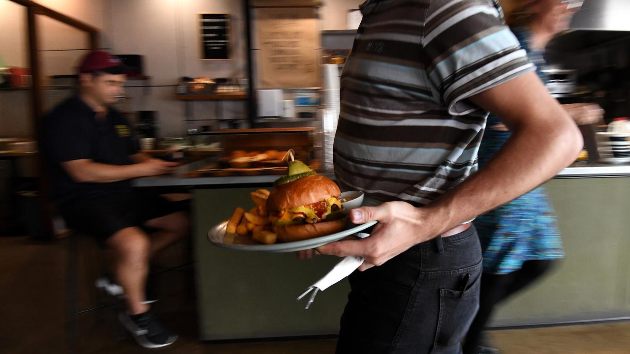 An employee serving a plate of food at a cafe (file image)