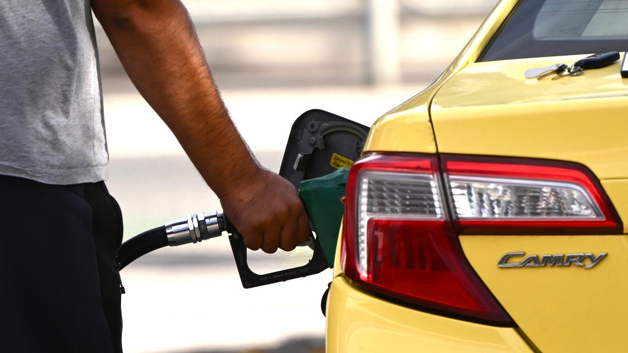 A customer uses a fuel pump to fill up a car