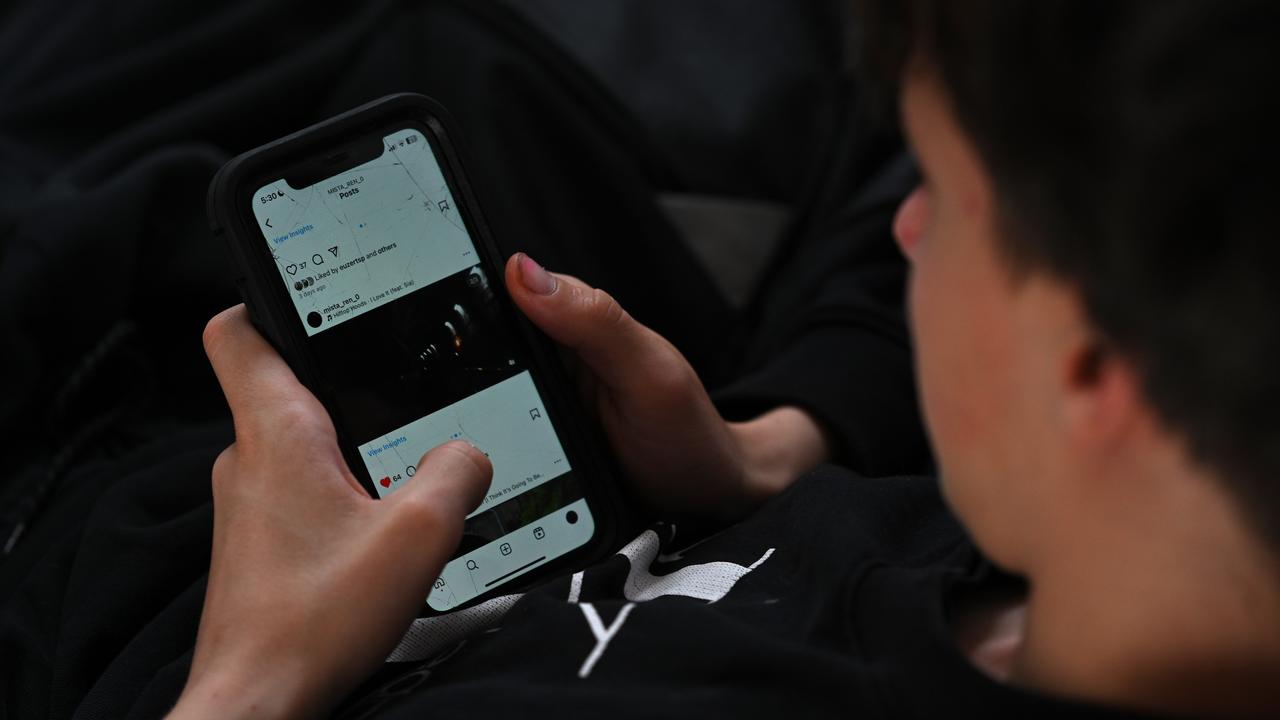 A teenager uses his mobile phone to access social media (file image)