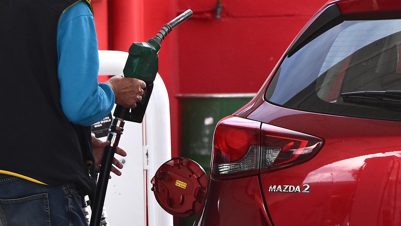A customer uses a fuel pump to fill up a car (file image)