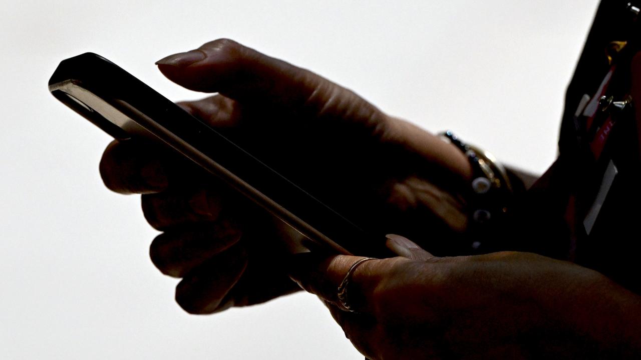 A woman seen using a smartphone device in Melbourne