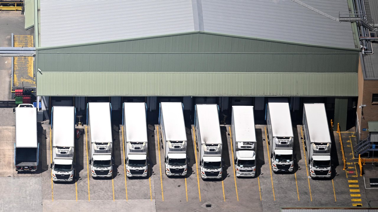 Trucks line up at a supply depot
