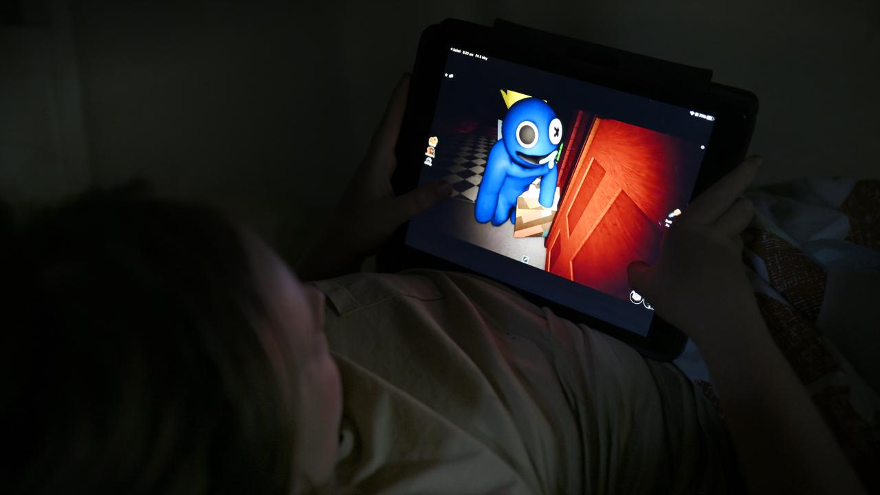 A child plays the Rainbow Friends Roblox game on his iPad in Sydney