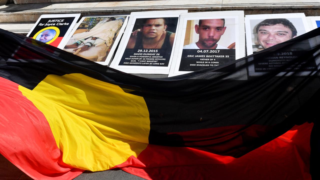 An indigenous flag unfurled under deaths in custody images