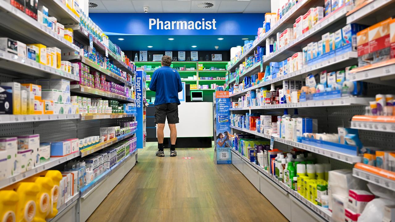 A customer waits at a counter at National Chemist pharmacy