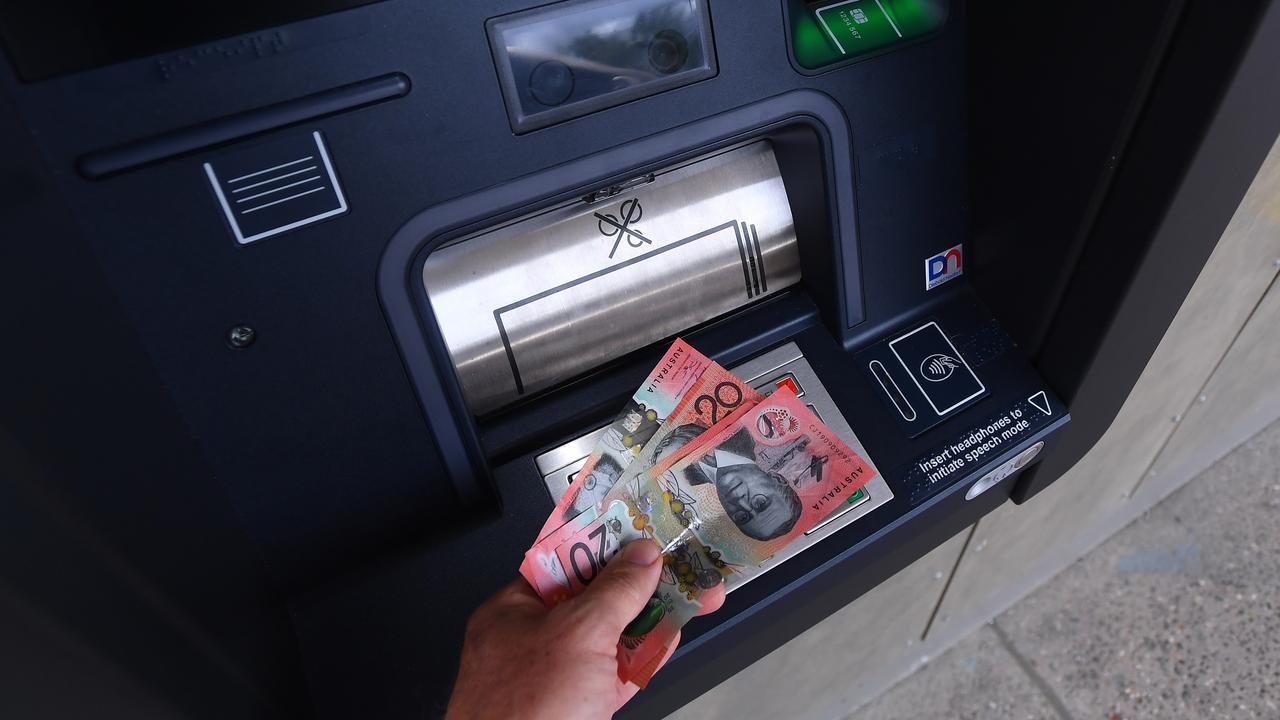 Cash is withdrawn from an ATM (file image)