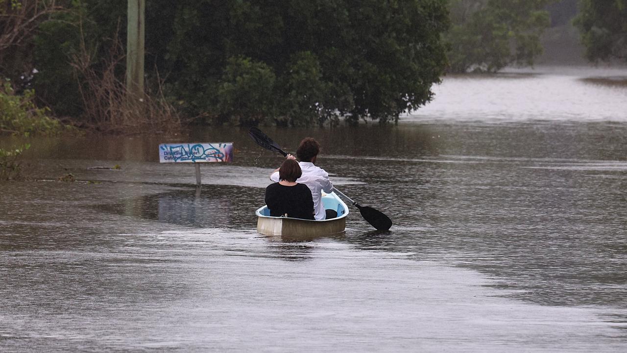 Residents paddle down a street in South Lismore, NSW, in March 2025