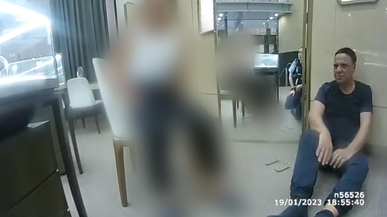 Michel German speaking to police after the staged robbery (file image)