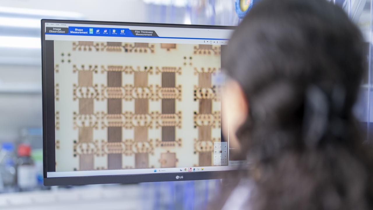 A Syenta employee looks at a computer screen