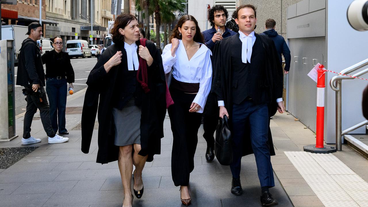 Charlotte MacInnes (centre) arrives at the Federal Court