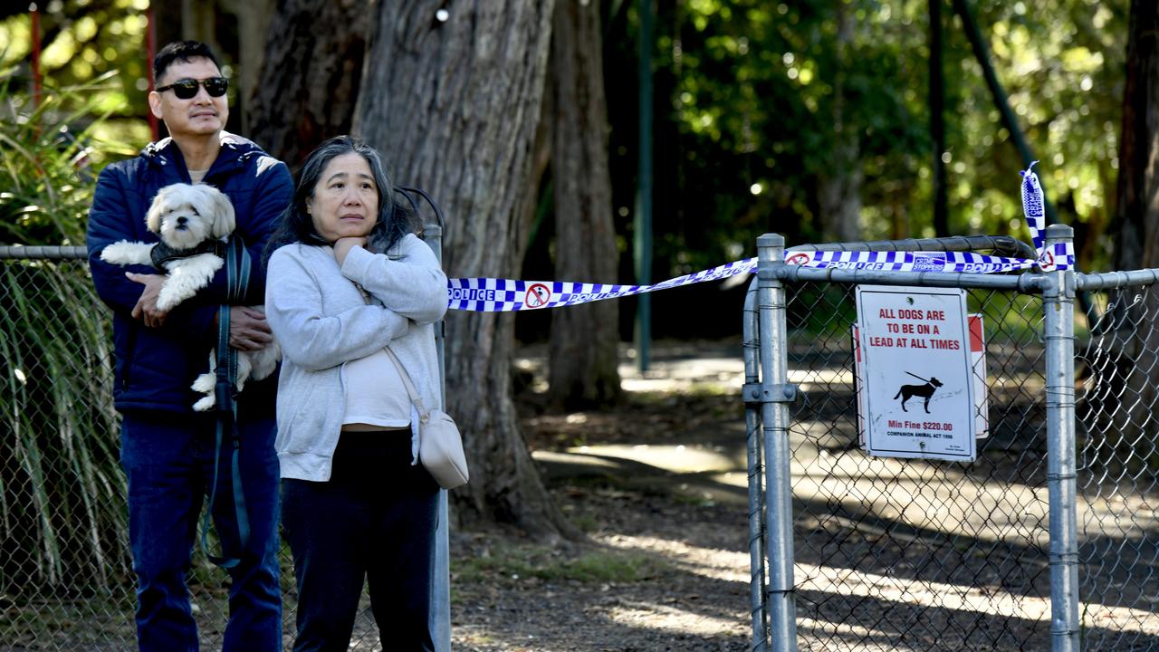 Residents look on as emergency services attend to the deadly blaze.