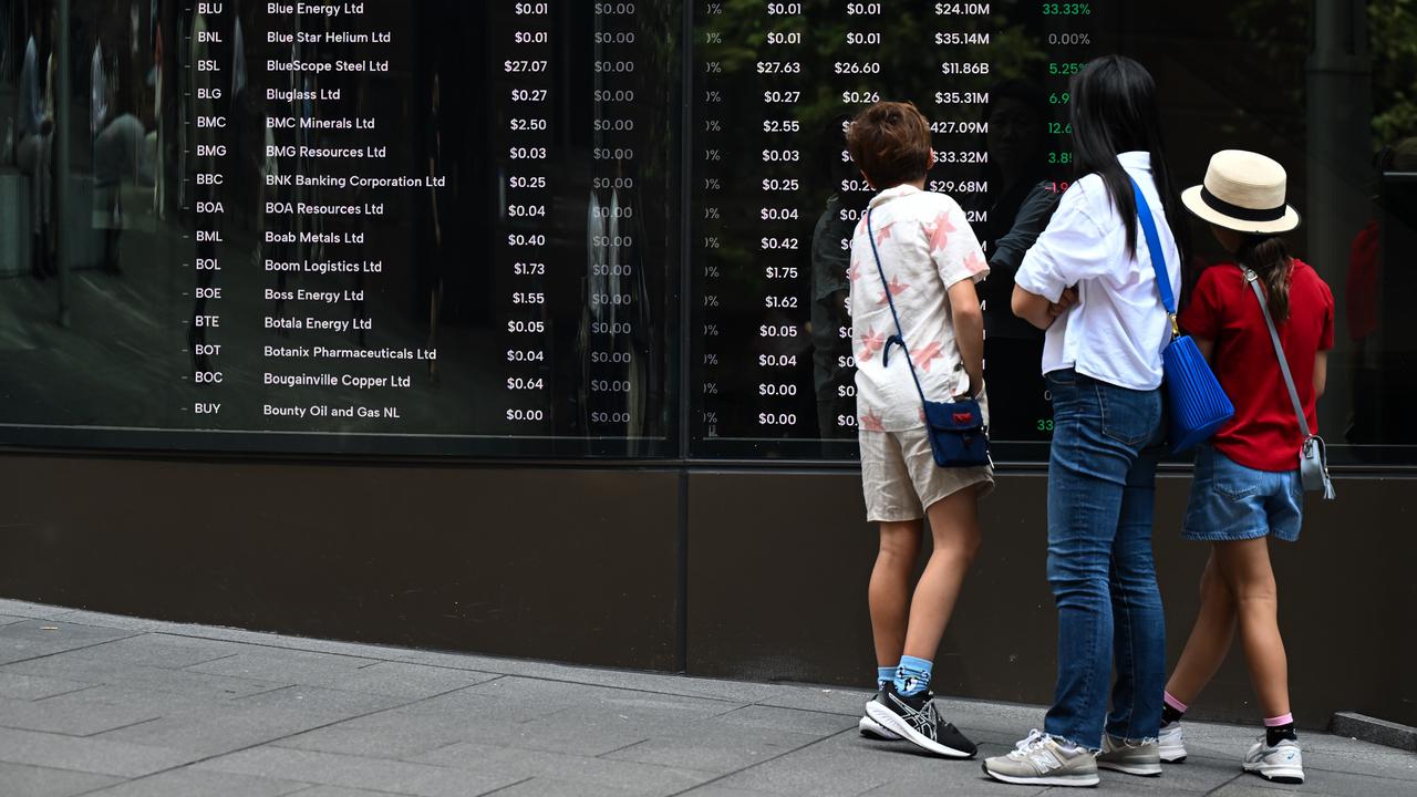 People looking at ASX stock boards